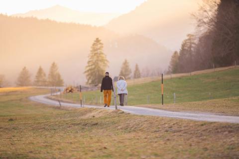 woman in black jacket and white pants walking on road during daytime by Wedding Dreamz courtesy of Unsplash.