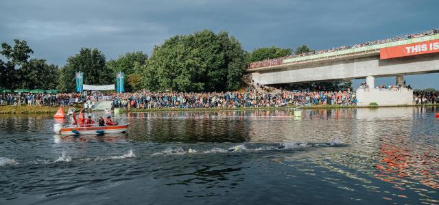 A group of people riding paddle boats on top of a lake by Janik Presser courtesy of Unsplash.