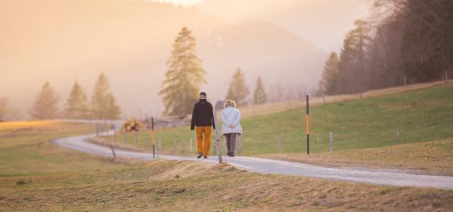 woman in black jacket and white pants walking on road during daytime by Wedding Dreamz courtesy of Unsplash.